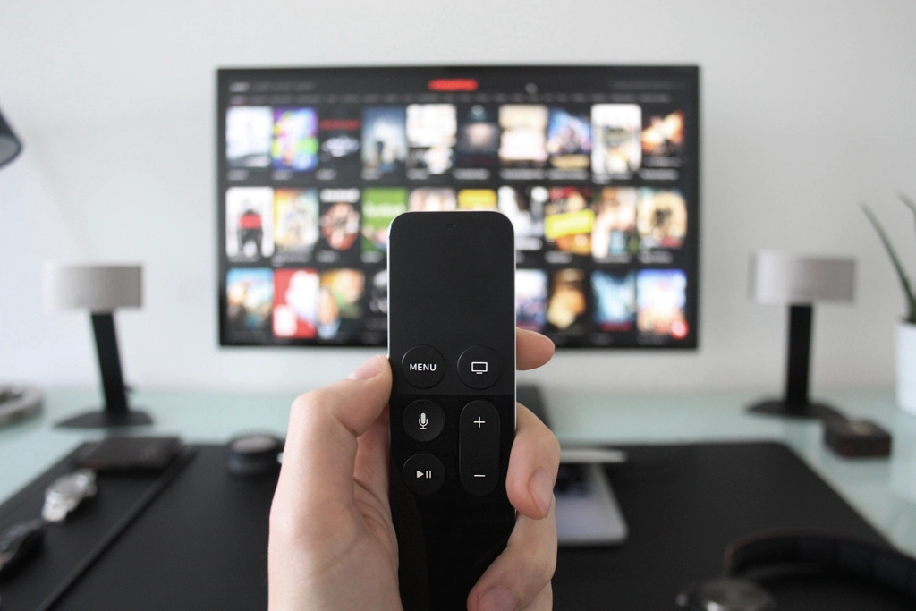 Hand holding Apple TV remote