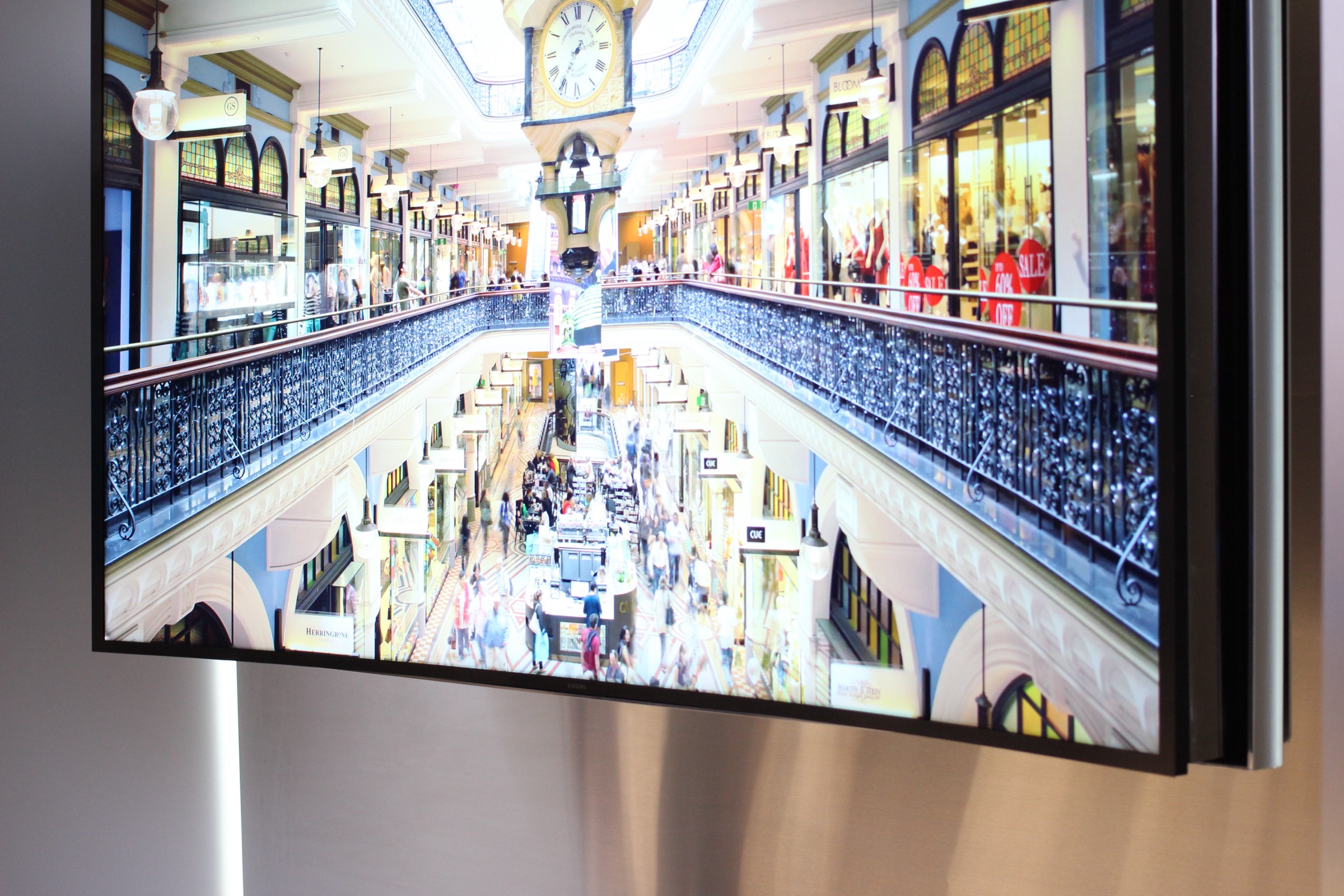 Close-up of a large curved 4K TV displaying a detailed indoor scene
