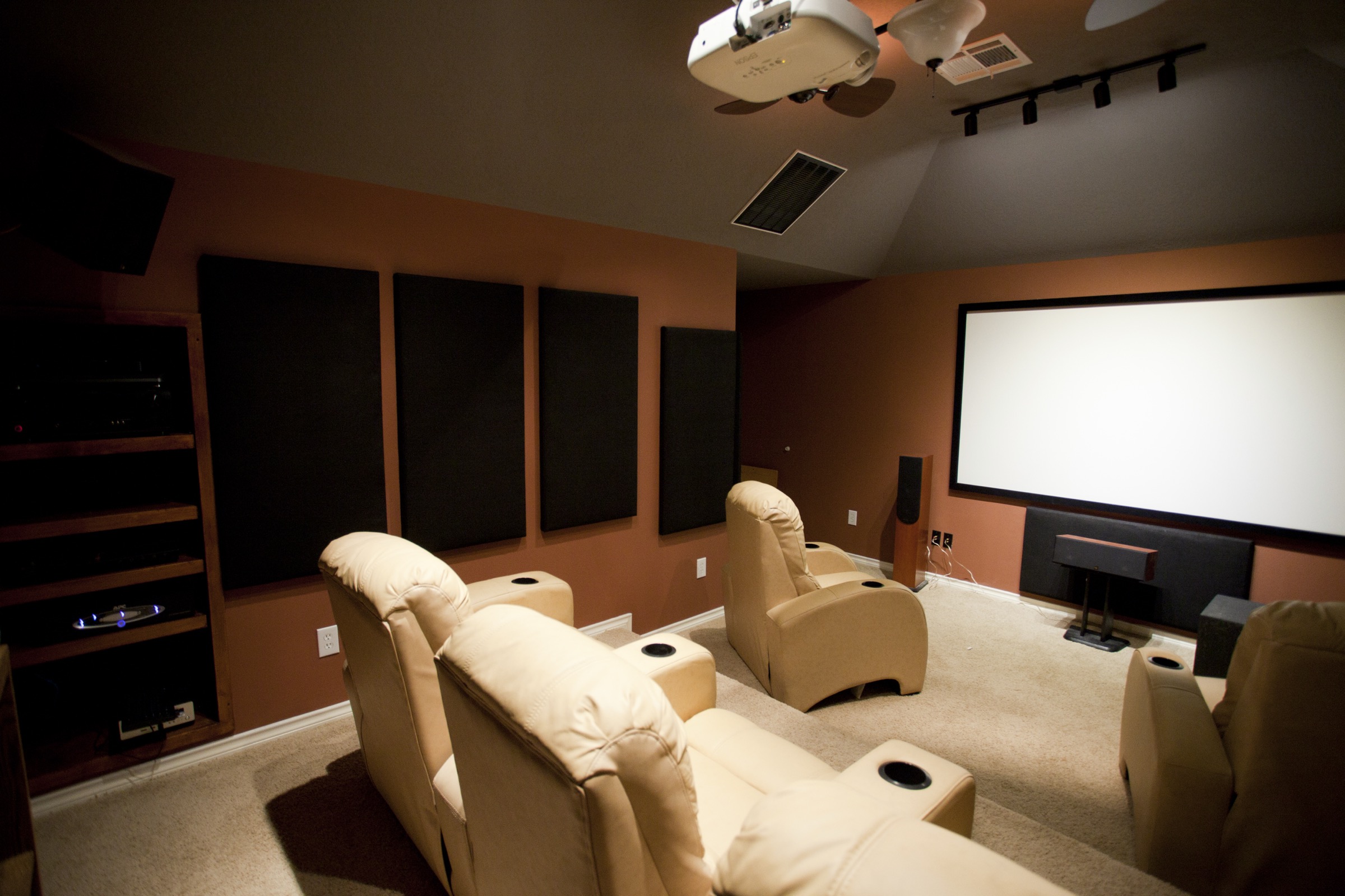 Home theater room with a ceiling-mounted projector and large projection screen